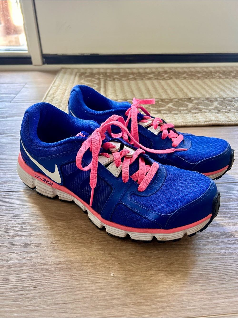 Nike Women's Blue Athletic Shoes with Pink Accents